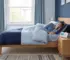 Person sleeping with a CPAP/APAP machine for sleep apnea therapy