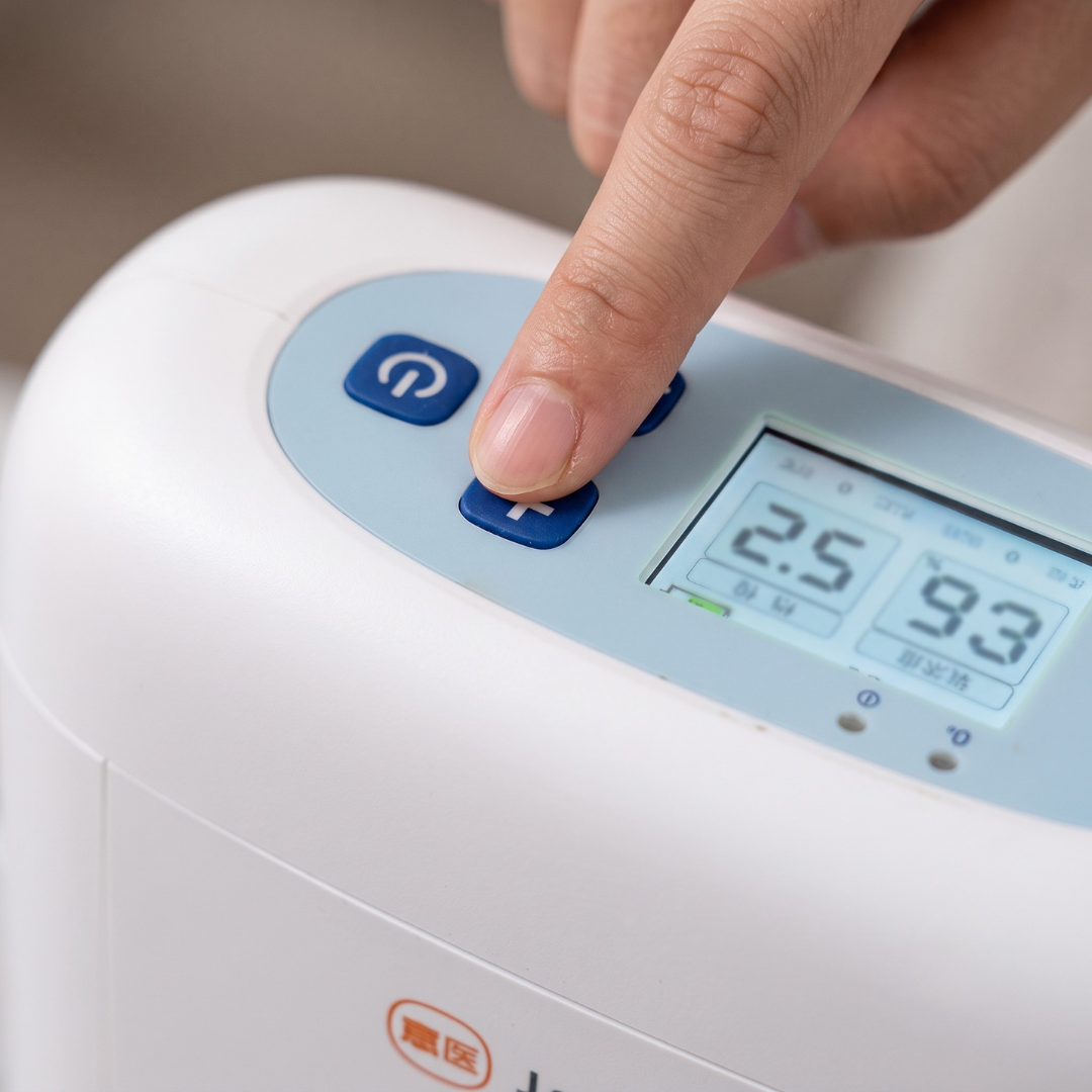 Close-up of an oxygen concentrator LCD display showing continuous flow setting